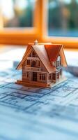 A house model on top of a blueprint photo