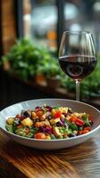A plate of food and a glass of wine on a table photo