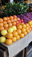 A table with oranges, grapes, and lemons photo