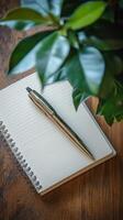 A pen and notepad on a table photo