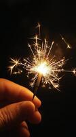 A person holding a sparkler in their hand photo