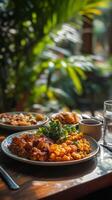 A table with a plate of food and a glass of water photo
