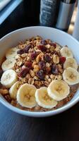 A bowl of cereal with bananas, nuts and dried cranberries photo