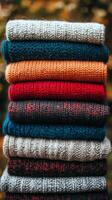 A stack of colorful knitted sweaters photo