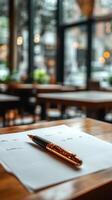 A pen and paper on a table in a restaurant photo