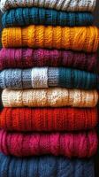 A stack of colorful sweaters photo