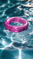 A pink ring floating in the water photo
