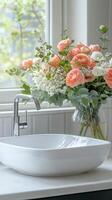 A vase of flowers sitting on a counter next to a sink photo