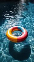 A colorful life ring floating in a pool photo