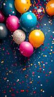 Colorful balloons and confetti on a blue background photo