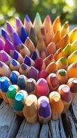 Colorful pencils arranged in a heart shape photo
