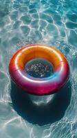 A colorful life ring floating in a pool of water photo
