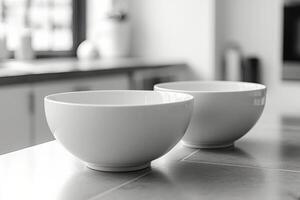Two white bowls on a kitchen counter photo