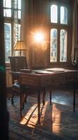 A desk with a lamp and a chair in front of a window photo