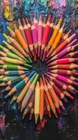 Colorful pencils arranged in a circle on a black background photo