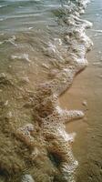 A wave is coming in to the beach photo