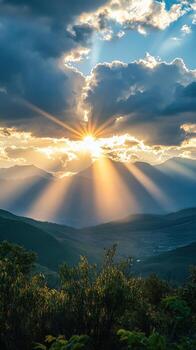 A sunset over a mountain range with a sunbeam shining through the clouds photo