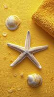 A starfish and a towel on a yellow background photo