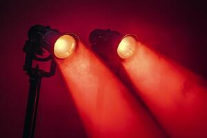 Two spotlight lights on a red background photo