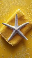 A starfish on a yellow towel photo