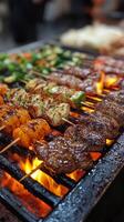 A grill with many different types of meat on skewers photo