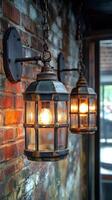Two light fixtures hanging from a brick wall photo