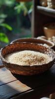 A bowl of rice sitting on a wooden table photo