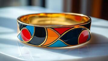 A colorful bracelet with a gold tone and black enamel photo