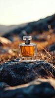 A bottle of perfume sitting on top of a rock photo