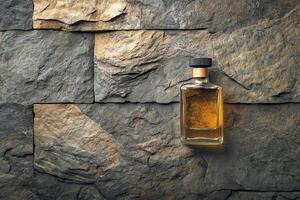 A bottle of whiskey on a stone wall photo