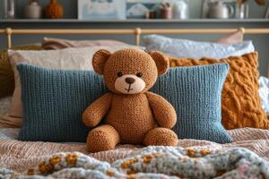 A teddy bear sits on a bed with pillows photo