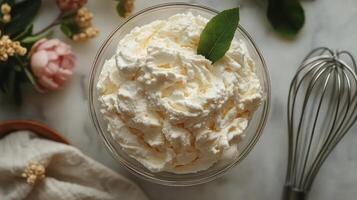 A bowl of whipped cream with a leaf on top photo