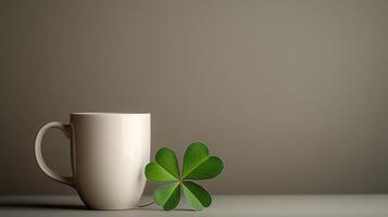 A cup with a shamrock leaf and a cup of coffee photo