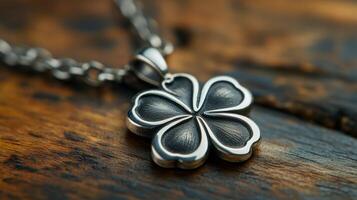 A silver clover pendant on a chain photo