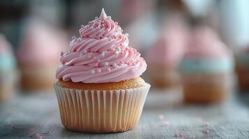 A cupcake with pink frosting on top photo