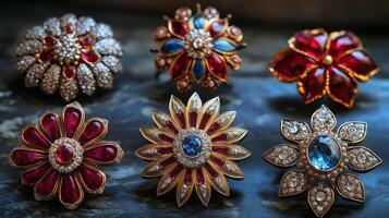 A group of six brooches with red, blue and white stones photo