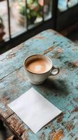 Coffee cup and paper on wooden table photo