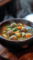 A bowl of soup with meatballs and vegetables photo