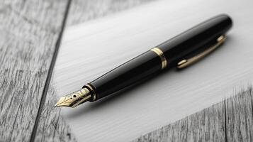 A black and gold fountain pen on a wooden table photo