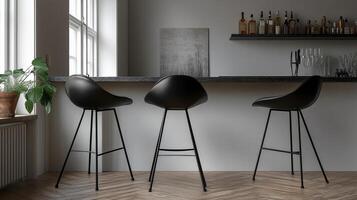 Three black stools in front of a bar photo