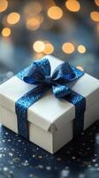Gift box with blue ribbon and christmas lights background photo