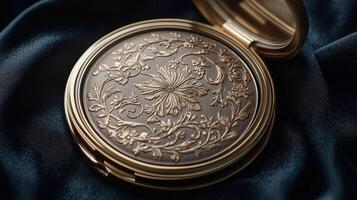A compact compact powder compact with a gold leaf design photo