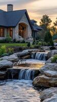 A home with a waterfall and rocks in front of it photo