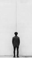 A man standing in front of a wall photo