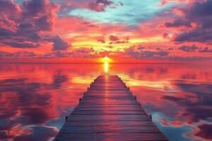 A wooden dock in the middle of a lake at sunset photo