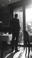 A man in a suit standing in front of a restaurant photo
