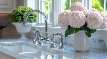 A kitchen sink with flowers in a vase photo