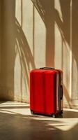 A red suitcase sitting on the floor photo