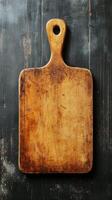 An old wooden cutting board on a black background photo