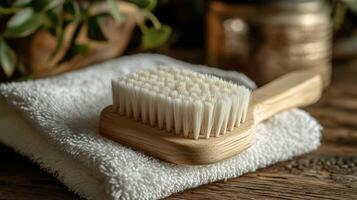 A wooden brush sitting on a towel on a table photo